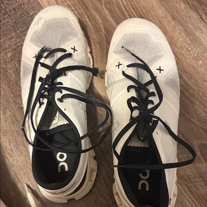 On Running Cream and Black Athletic Shoes